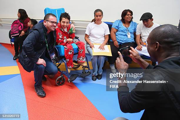 Clarence Seedorf takes picture of Predrag Mijatovic as he and the FIFA Legends visit the Teleton foundation rehabilitation center at CRIT Estado de...