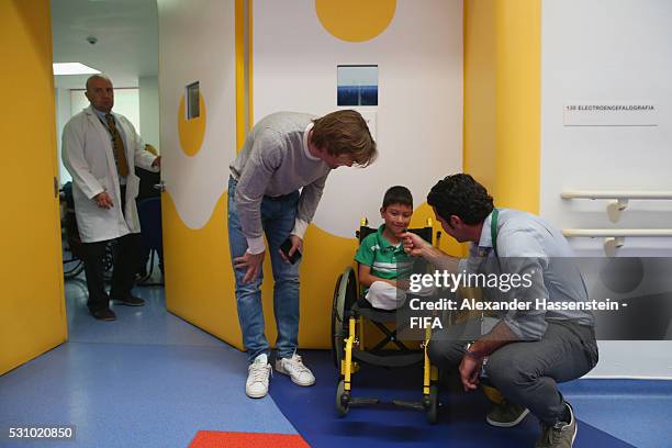 Dario Simic and Luis Figo talks to boy as they and the FIFA Legends visit the Teleton foundation rehabilitation center at CRIT Estado de M��xico...