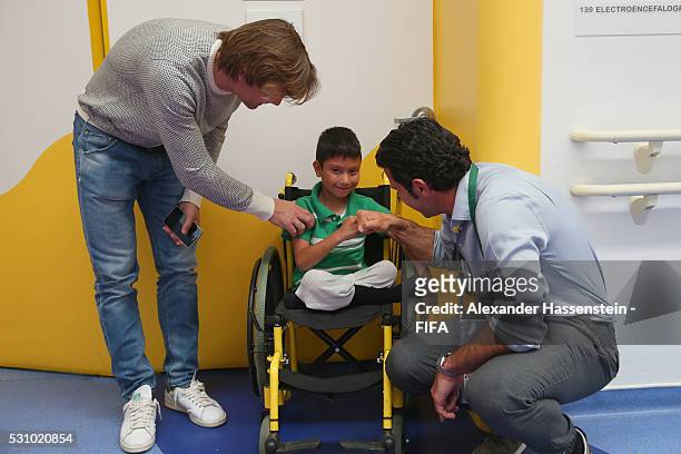 Dario Simic and Luis Figo talks to boy as they and the FIFA Legends visit the Teleton foundation rehabilitation center at CRIT Estado de M��xico...