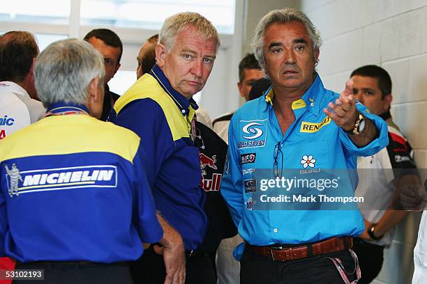 Team Principle Flavio Briatore of Renault with Nick Sherrock of Michelin talk after team meetings were held to decide whether the race would go ahead...