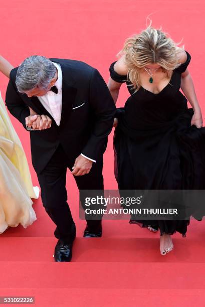 Actors George Clooney and Julia Roberts arrive on May 12, 2016 for the screening of the film "Money Monster" at the 69th Cannes Film Festival in...