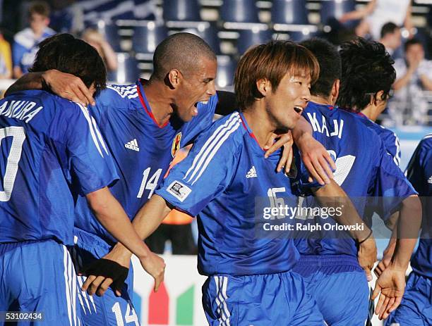 Shunsuke Nakamura is congratulated by Alessandro Santos and Masashi Oguro of Japan after his goal during the match between Greece v Japan in the FIFA...