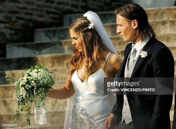 Roma captain Francesco Totti smiles to his wife Italian TV star Hilary Blasi leave the church after their wedding 19 June 2005 in Rome. AFP...