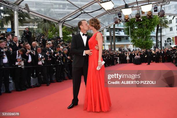 Italian pornographic actor Rocco Siffredi kisses his wife Rosa Caracciolo on May 12, 2016 as they arrive for the screening of the film "Money...