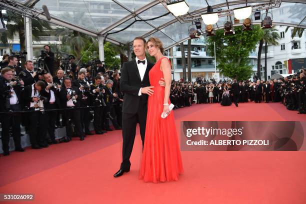 Italian pornographic actor Rocco Siffredi and his wife Rosa Caracciolo pose on May 12, 2016 as they arrive for the screening of the film "Money...