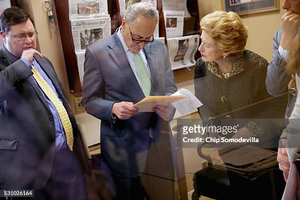 Sen. Charles Schumer talks with Sen. Debbie Stabenow prepare for a news conference following meetings between Republican presidential candidate...