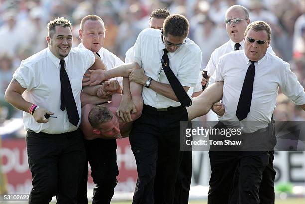 Security escort a streaker off the field during the NatWest Series One Day International between England and Australia played at the County Ground on...