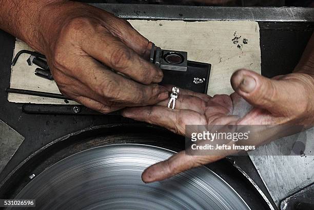 Craftsman looks through a loupe to inspect diamonds at the Martapura Jewelry production facility on May 12, 2016 in Martapura, Indonesia. The city is...