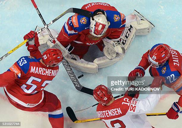 Denmark's forward Mads Christensen attacks Russia's goalie Ilya Sorokin next to Russia's defender Alexei Marchenko and Russia's defender Nikita...