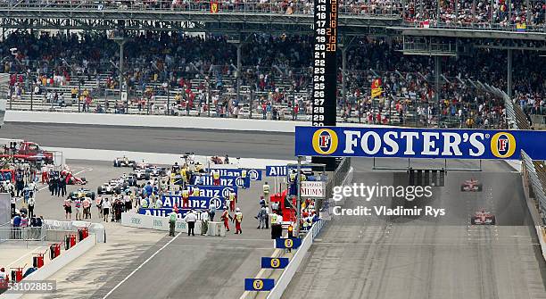 Drivers with Michelin tyres are seen driving in to the pits after the warm-up lap, both Ferrari cars of Michael Schumacher and Rubens Barrichello who...