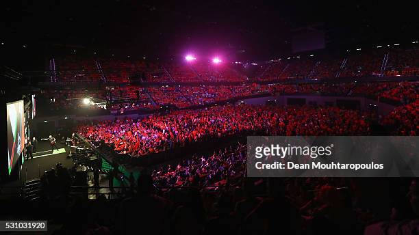 General view of the large crowd mainly wearing the national colour of Orange cheers as Raymond van Barneveld of the Netherlands plays a shot in his...