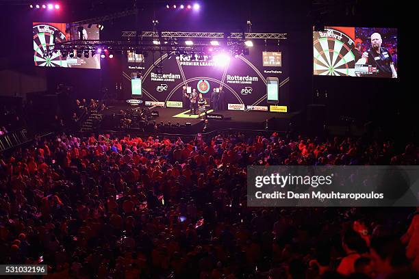 General view of the large crowd mainly wearing the national colour of Orange cheers as Raymond van Barneveld of the Netherlands plays a shot in his...