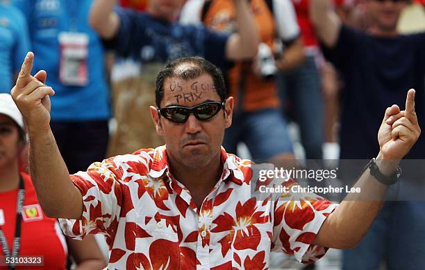 American Formula One fan puts his middle fingers up and writes " US Gone Prix " on his head after all the teams with Michelin tyres retired after the...