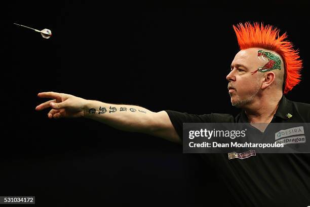 Peter Wright of Scotland plays a shot in his match against Raymond van Barneveld of the Netherlands during the Darts Betway Premier League Night 15...