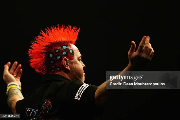 Peter Wright of Scotland dances for the fans before he plays against Raymond van Barneveld of the Netherlands during the Darts Betway Premier League...