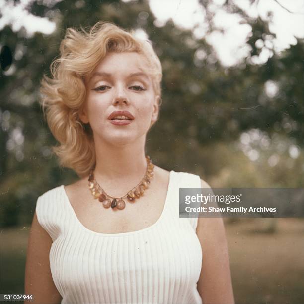 Marilyn Monroe poses wearing an amber bead necklace in 1957 in Amagansett, New York.