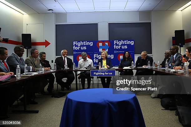 Democratic presidential front-runner Hillary Clinton speaks with a coalition of HIV/AIDS activists at her Brooklyn Campaign Headquarters on May 12,...