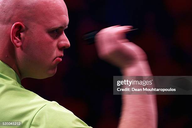 Michael van Gerwen of the Netherlands plays a shot in his match against Phil 'The Power' Taylor of England during the Darts Betway Premier League...