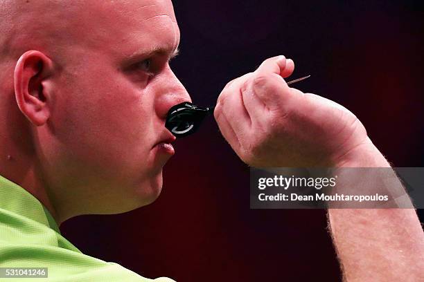 Michael van Gerwen of the Netherlands plays a shot in his match against Phil 'The Power' Taylor of England during the Darts Betway Premier League...