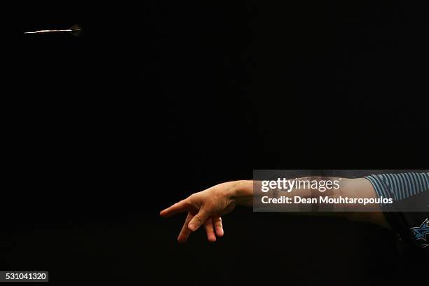 Phil 'The Power' Taylor of England plays a shot in his match against Michael van Gerwen of the Netherlands during the Darts Betway Premier League...