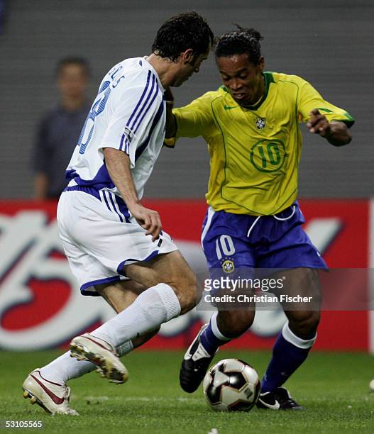 Ioannis Goumas of Greece and Ronaldinho of Brazil fight for the ball during the FIFA Confederations Cup 2005 Match between Brazil and Greece on June...