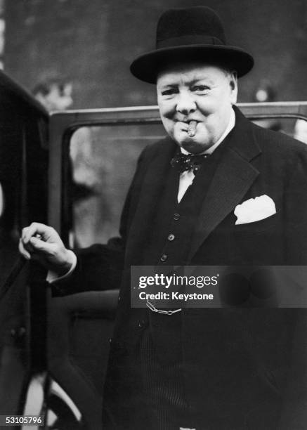 British Prime Minister Winston Churchill steps into his car at the rear of Downing Street on his way to hand in his resignation to King George VI,...