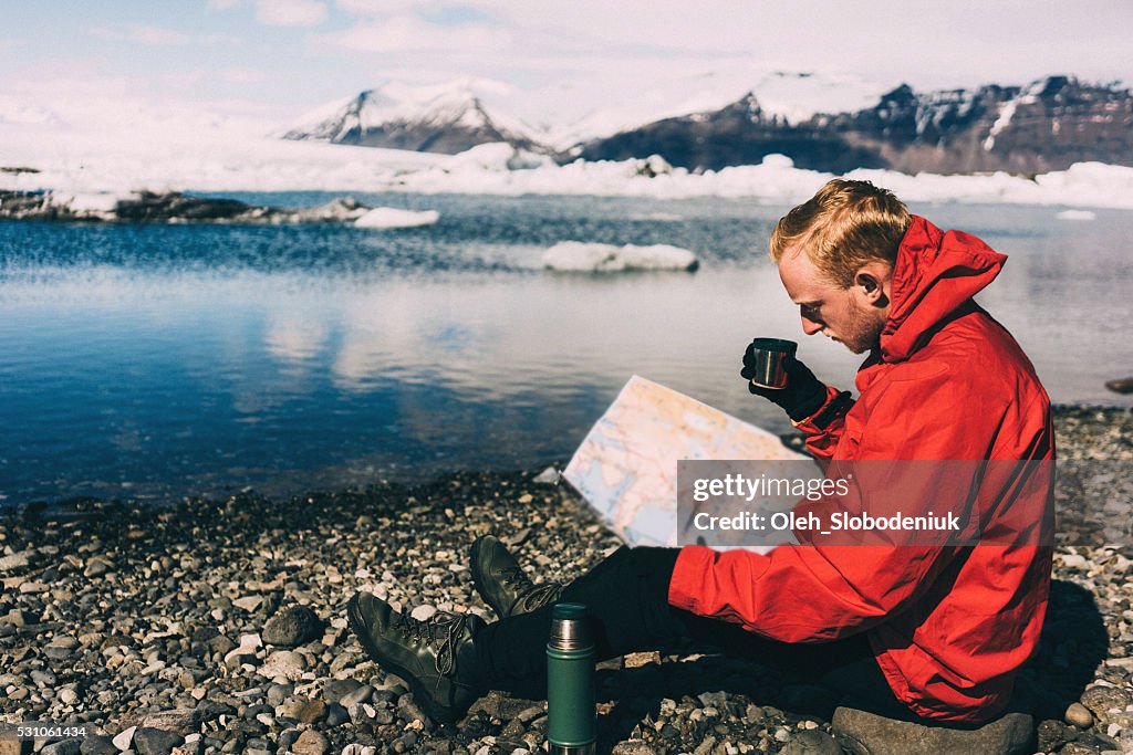 Man walking near the lake with glaciers