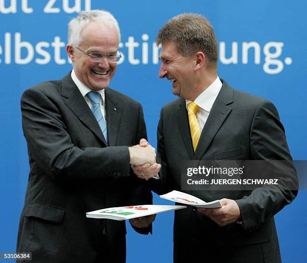 Juergen Ruettgers leader of the Christian Democratic Union party in North Rhine-Westphalia , and NRW's Free Democrats leader Andreas Pinkwart shake...