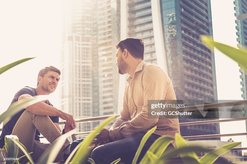 Friends talking outside their office building