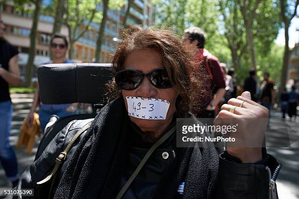 Demonstrator has her mouth shut by a scotch-tape reading '49.3' during a demonstration against the El-Khomri bill and the use of article 49.3 by...