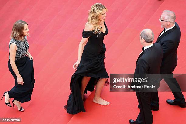 Producer Jodie Foster and actress Julia Roberts, walking bare foot, attend the "Money Monster" premiere during the 69th annual Cannes Film Festival...