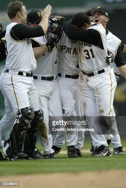David Ross, Jack Wilson , Freddy Sanchez, and Daryle Ward of the Pittsburgh Pirates celebrate a victory after the against the Florida Marlins at PNC...
