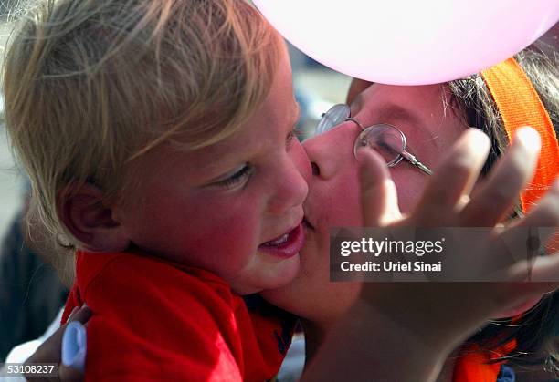 One of five Young Jewish settler girls kisses her baby brother as they are given a hero?s welcome on their return from Israeli detention on June 20...