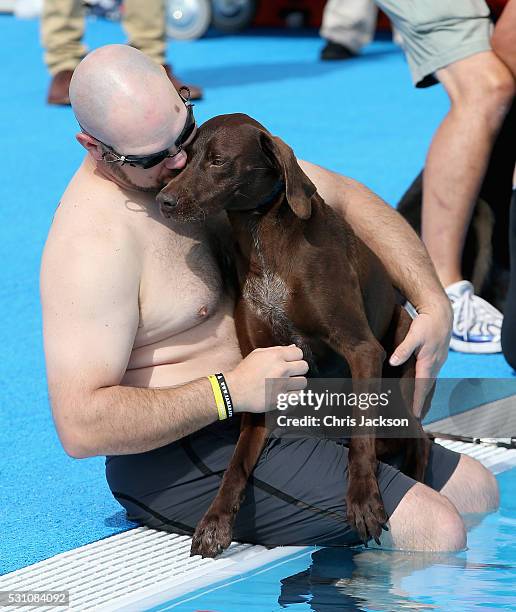 Service dogs take part in a race in the pool with their Invictus competitor handlers on the final day of the Invictus Games Orlando 2016 at ESPN Wide...