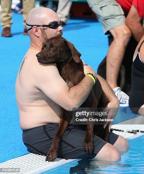 Service dogs take part in a race in the pool with their Invictus competitor handlers on the final day of the Invictus Games Orlando 2016 at ESPN Wide...