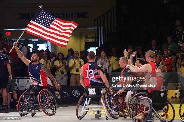 Player for the United States squad carries the American flag on the court during the Invictus Games Orlando 2016 Wheelchair Basketball Finals at the...