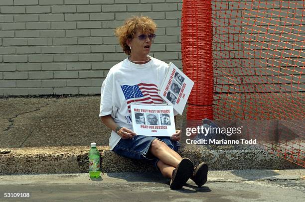 Beth Tennyson is seen with her prayer sign behind the Neshoba County Courthouse on June 20, 2005 in Philadelphia, Mississippi. Tennyson came to the...