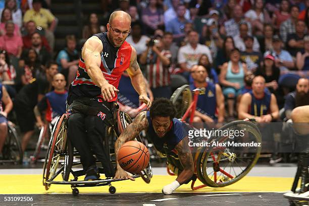 Anthony McDaniel of the United States crashes during action against the United Kingdom at the Invictus Games Orlando 2016 Wheelchair Basketball...