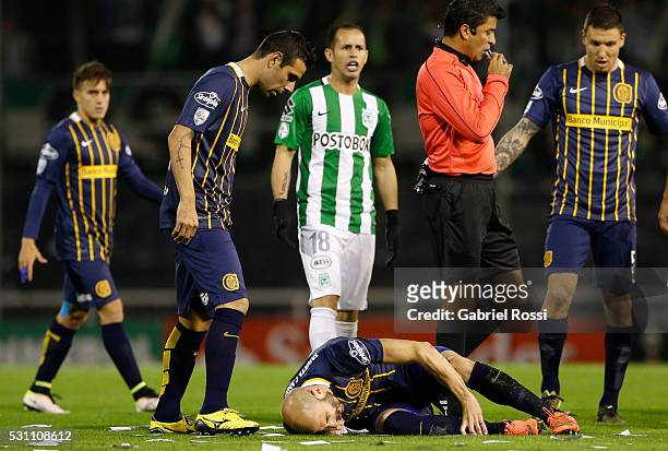 Javier Pinola of Rosario Central lies injured after receiving a foul from Felipe Aguilar of Atletico Nacional during a first leg match between...