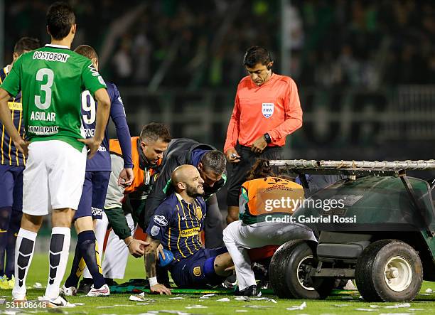 Javier Pinola of Rosario Central lies injured after receiving a foul from Felipe Aguilar of Atletico Nacional during a first leg match between...