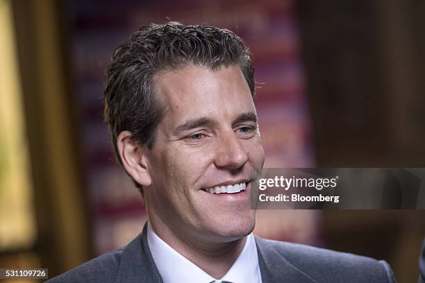 Cameron Winklevoss, chief executive officer and co-founder of Gemini Trust Company LLC, left, smiles during a Bloomberg West Television interview...