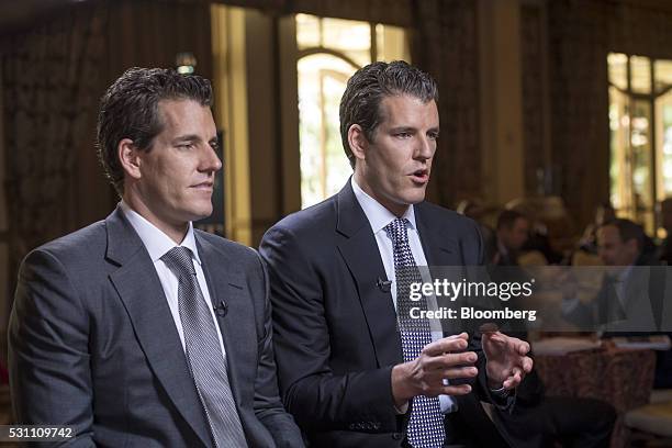 Cameron Winklevoss, chief executive officer and co-founder of Gemini Trust Company LLC, left, listens as Tyler Winklevoss, chief financial officer...