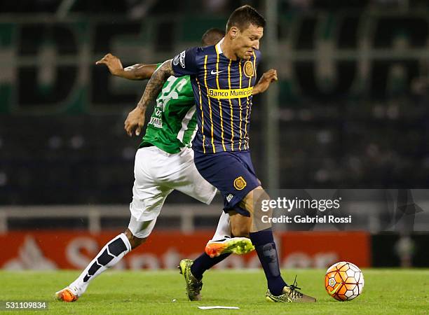 Damian Musto of Rosario Central fights for the ball with Jonathan Copete of Atletico Nacional during a first leg match between Rosario Central and...