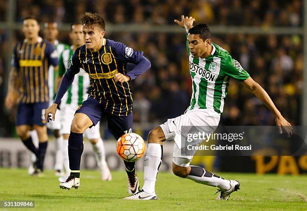 Franco Cervi of Rosario Central fights for the ball with Daniel Bocanegra of Atletico Nacional during a first leg match between Rosario Central and...