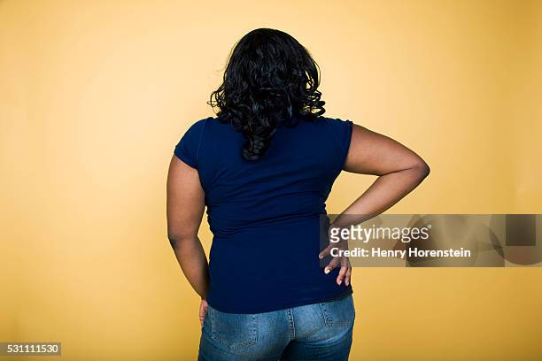 back view of woman with hand on hip - fat people stock pictures, royalty-free photos & images