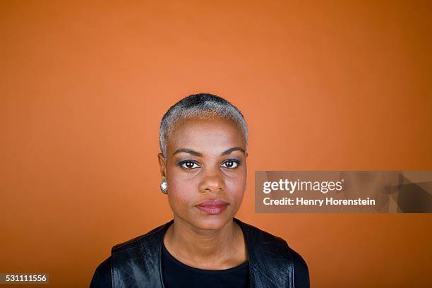 middle-aged woman - portrait orange background stock pictures, royalty-free photos & images