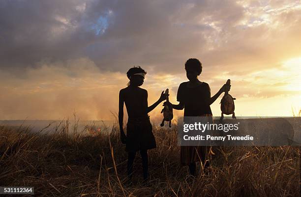 Monica and her brother Alberto with long necked turtles they caught in the Arafura swamp near Giymir, Arnhem land. This area is only accessible...