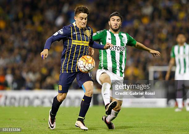 Franco Cervi of Rosario Central fights for the ball with Sebastian Perez of Atletico Nacional during a first leg match between Rosario Central and...