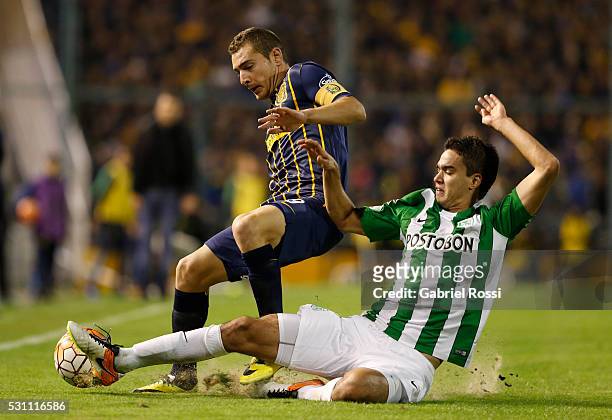 Marco Ruben of Rosario Central battles for the ball with Felipe Aguilar of Atletico Nacional during a first leg match between Rosario Central and...