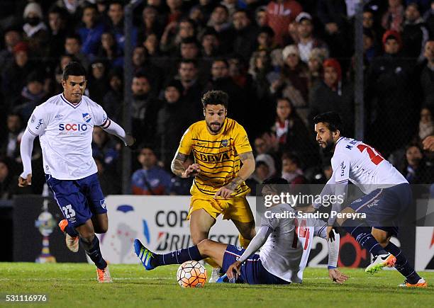 Daniel Osvaldo of Boca Juniors fights for the ball with Gonzalo Porras during a first leg match between Nacional and Boca Juniors as part of quarter...